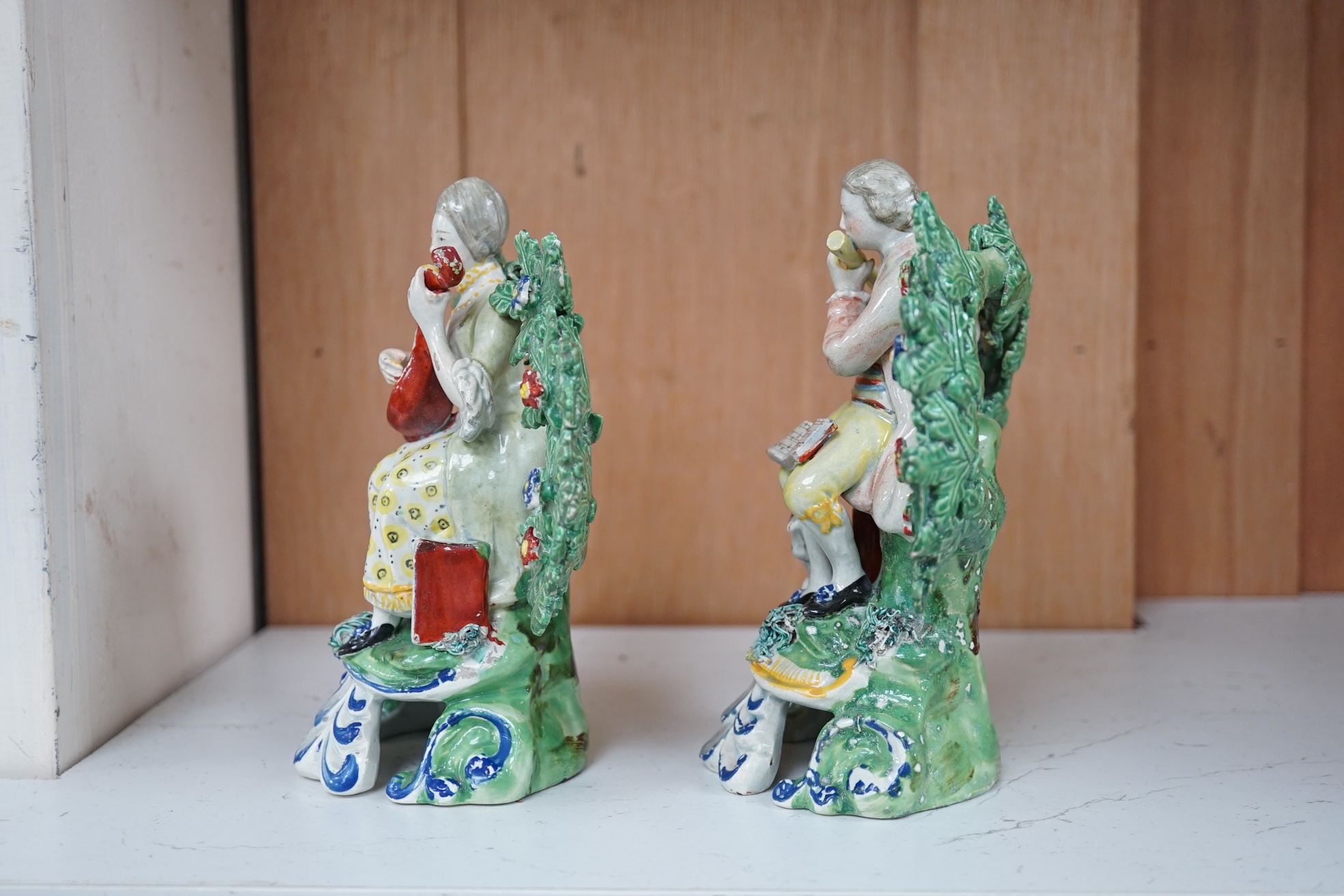 A pair of early 19th century pearlware groups of seated musicians with dogs, 15.5 cm high, Condition - minor faults otherwise fairly good, provenance - sold by Jonathan Horne Antiques